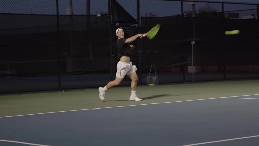 White man playing tennis in a tennis court