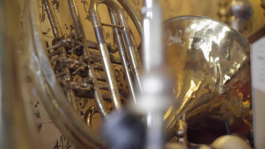 The trumpet is leaning against the wall