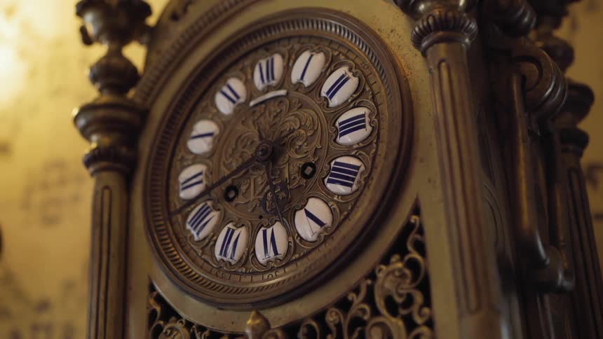 A classic wooden clock sits next to a wall