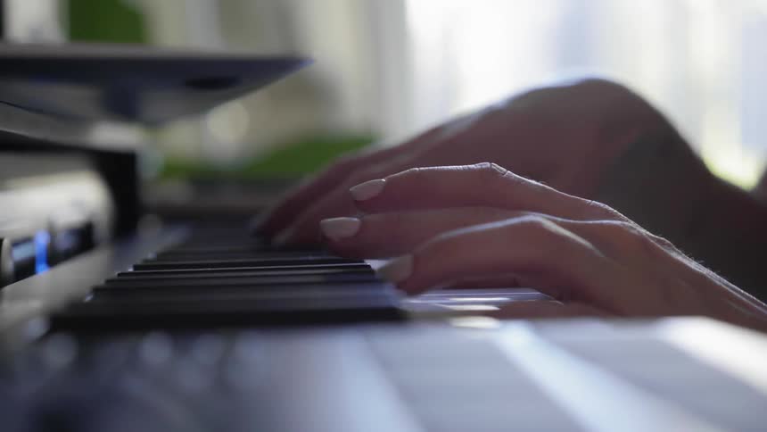 Hands playing piano