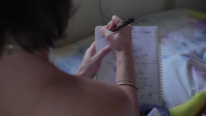 Woman writes in notebook