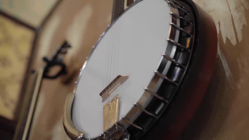 A banjo hangs on a wall