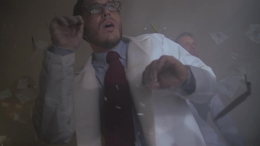 Scientist looks astonished at the objects floating around him