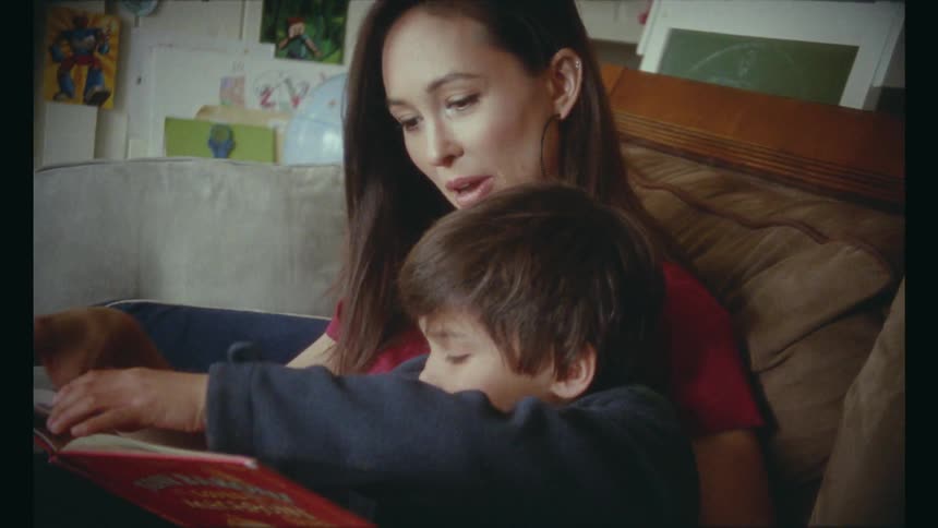 Woman reads book to son