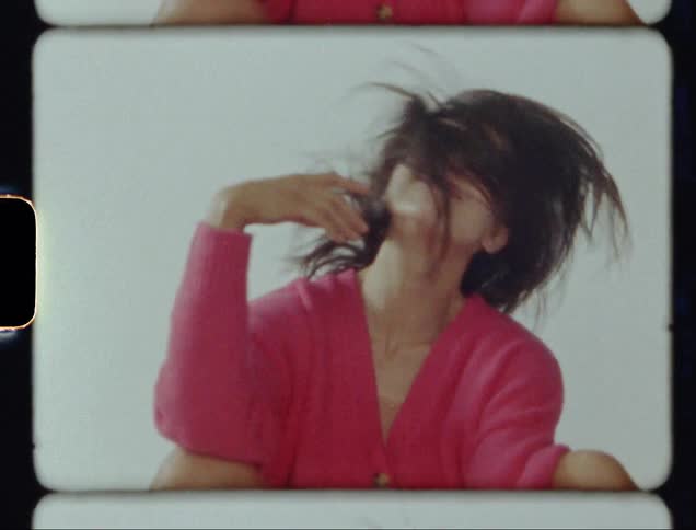Vintage film of woman looking at the camera and smiling