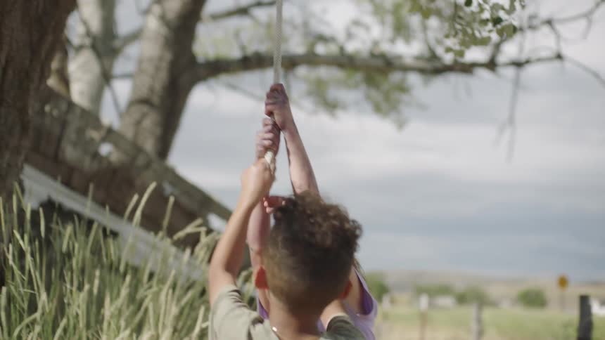 A boy and a girl playing with a rope