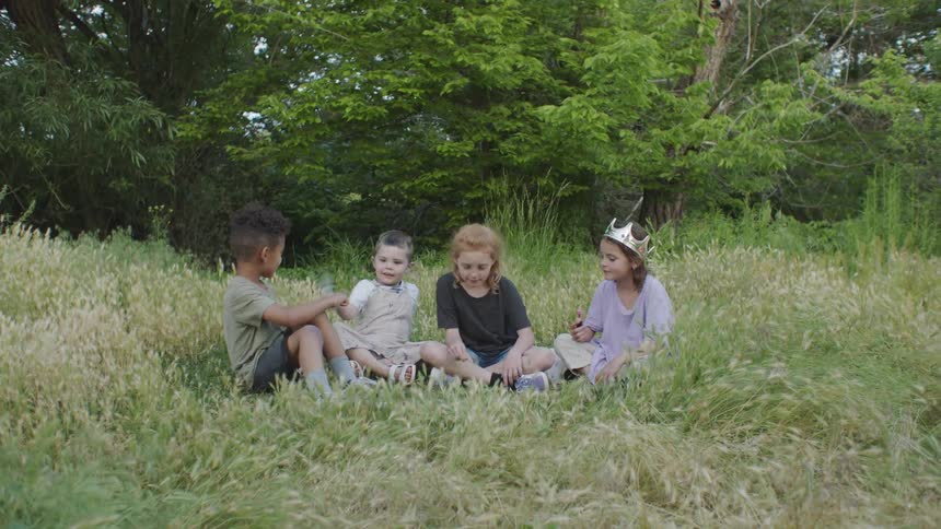 Kids are playing in the grass