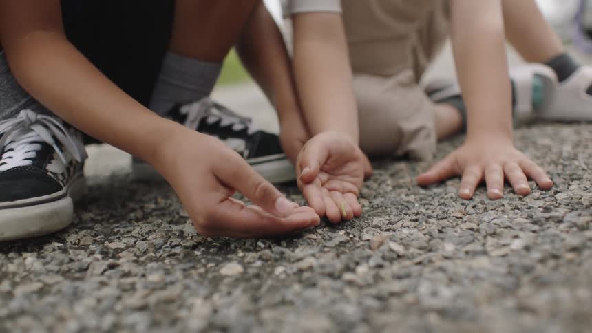 Little kids play with a caterpillar
