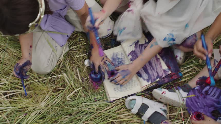 A group of kids playing with paint