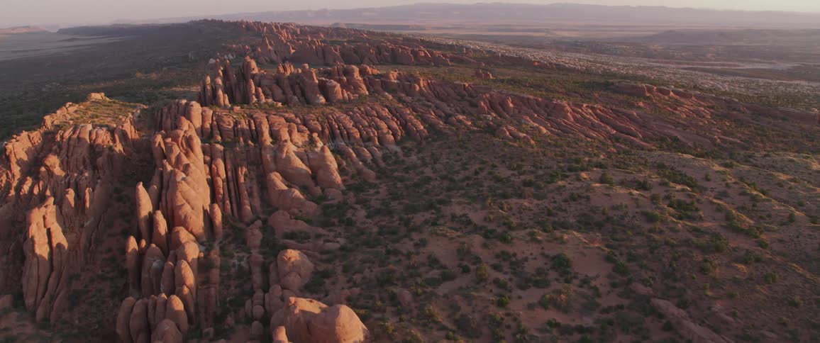 A field is filled with canyons of varying heights and peaks
