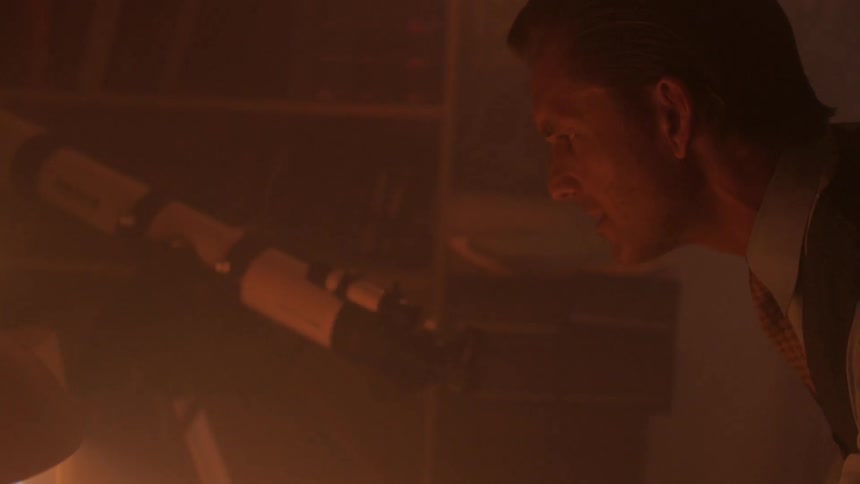 A man using a telescope