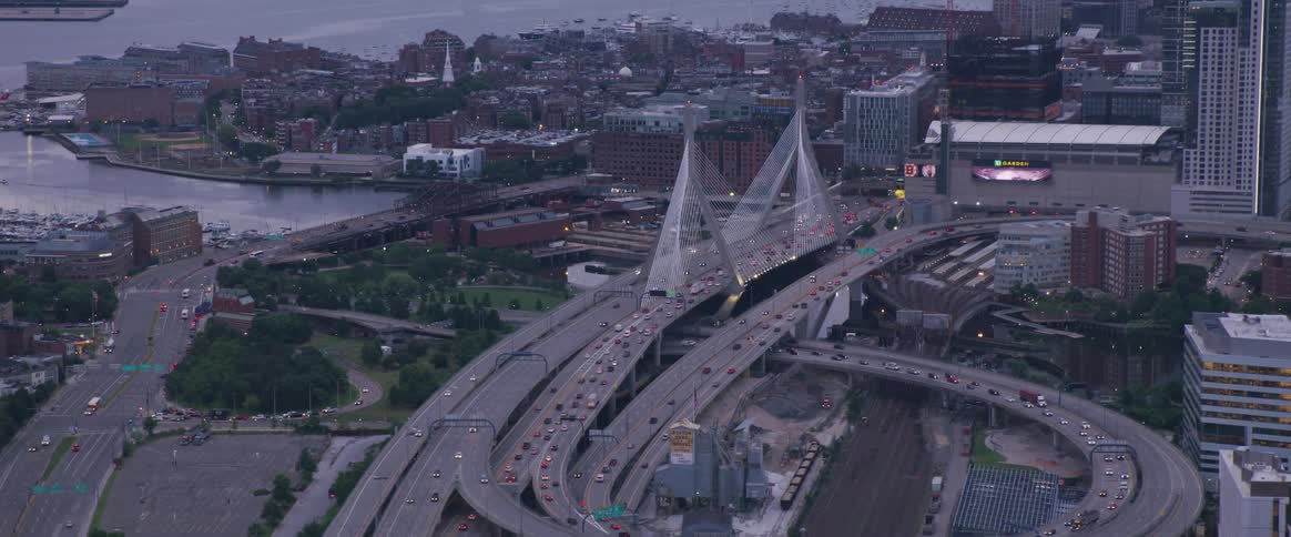 A highway with cars and buildings in the background