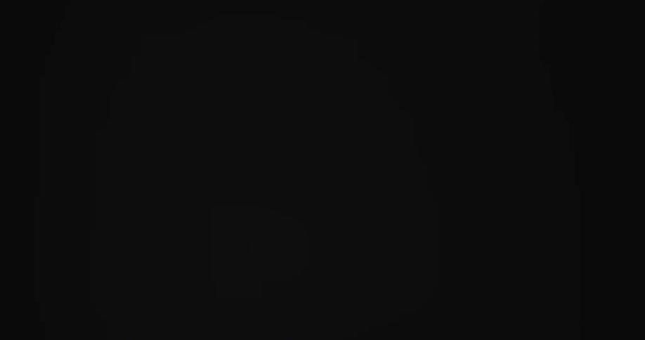 Small pieces of paper fluttering downward against a dark background