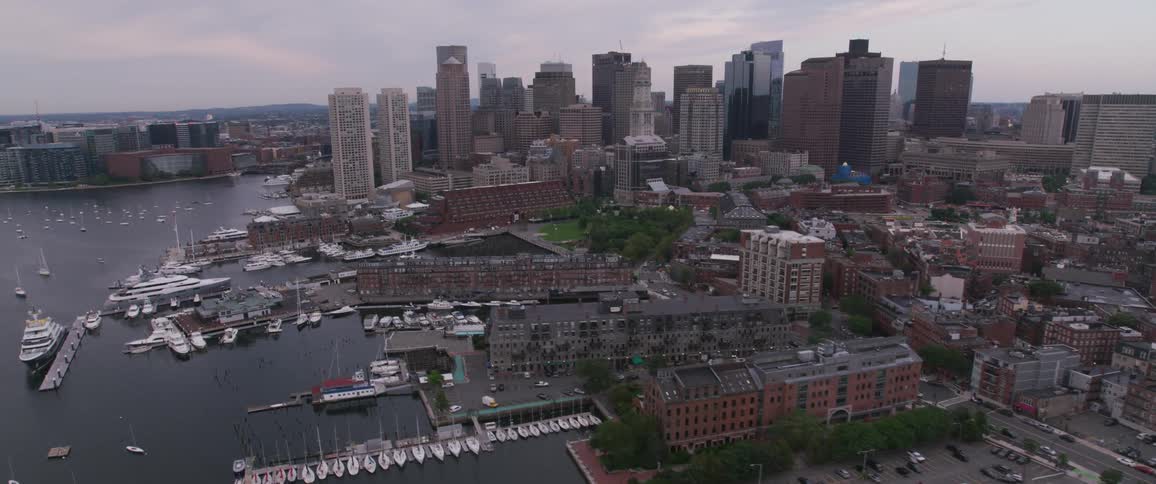 Yachts and boats are docked and anchored along Boston's waterfront