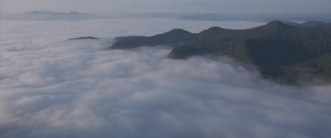 Mountains rising above cloud filled valley