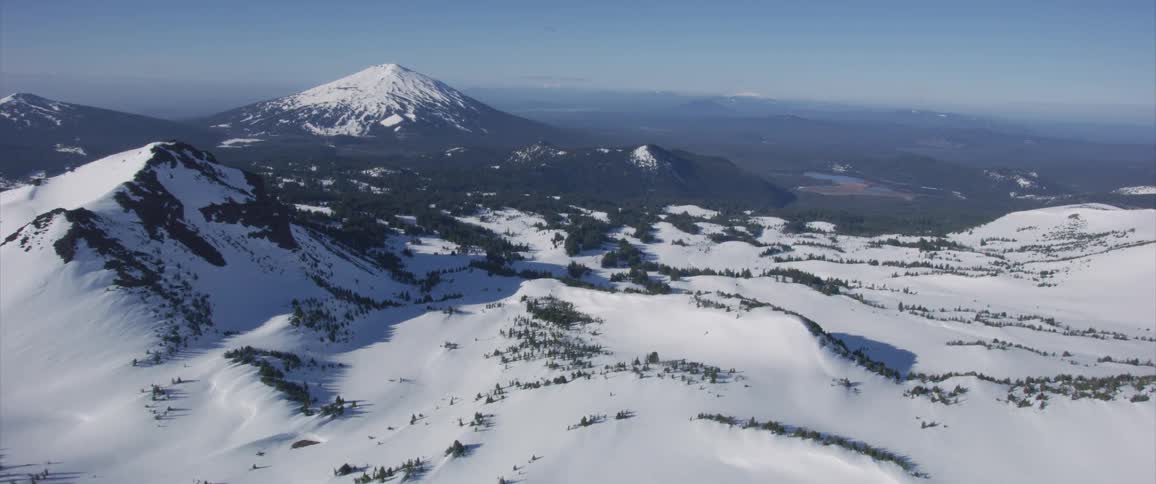 A sprawling field of snow and mountains
