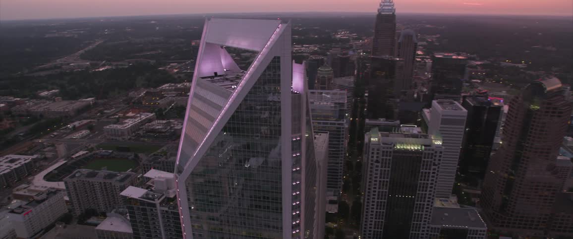 A purple tinged skyscraper looms above the city