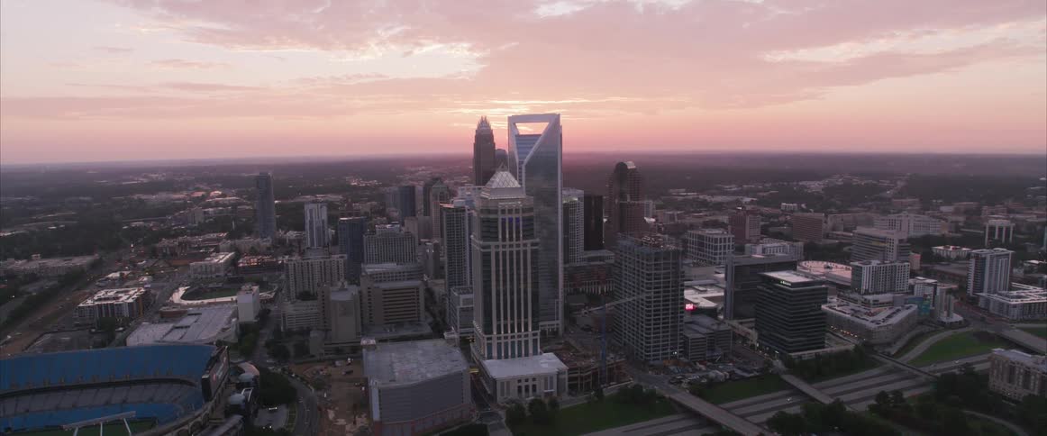 Overview of downtown city as sun sets on horizon