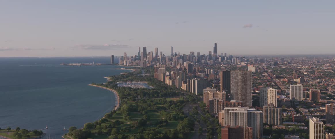 Skyline of the the city with tall buildings next to the sea on a sunny day