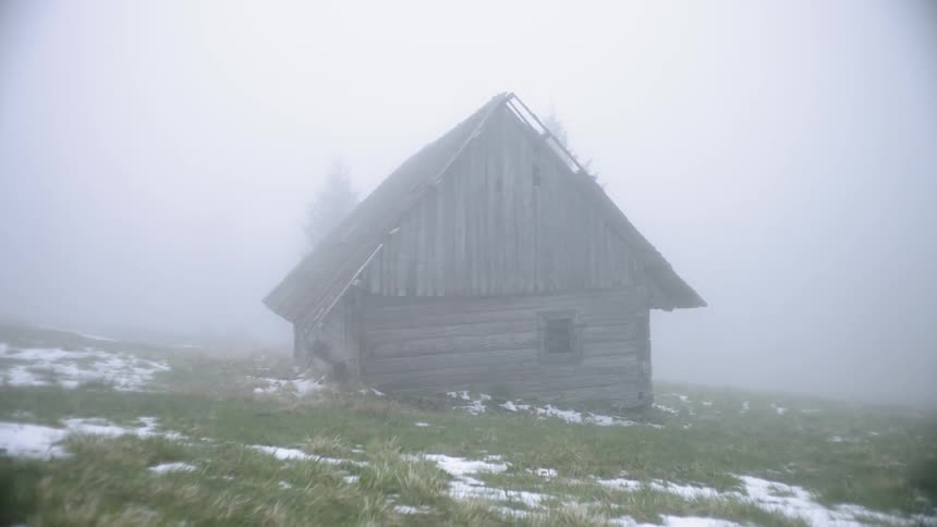 Fog and snow around old worn house