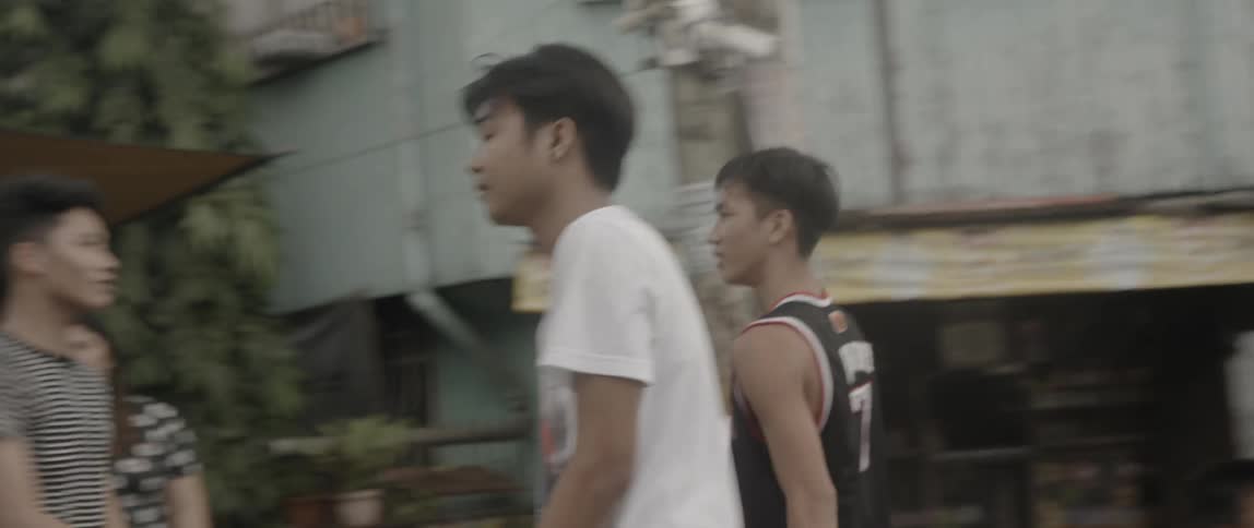 A group of boys play basketball together