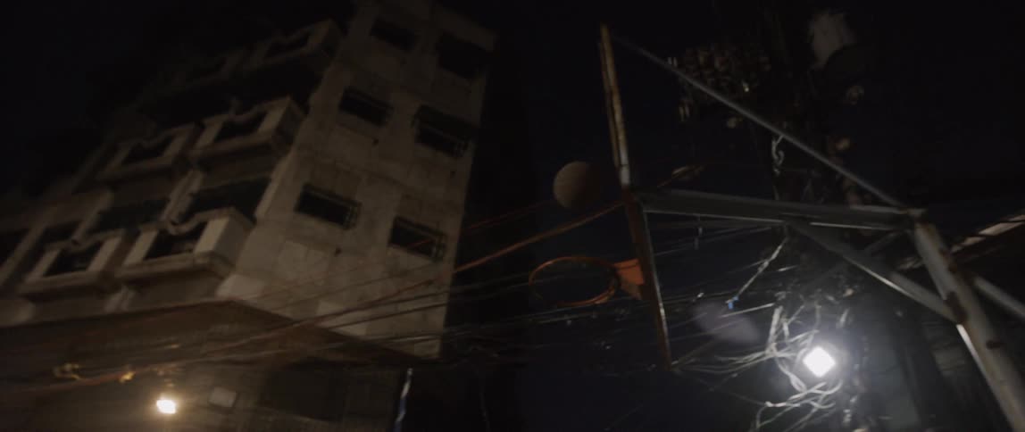 Men play basketball in the street