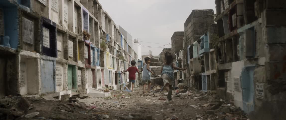 Three children running down a road