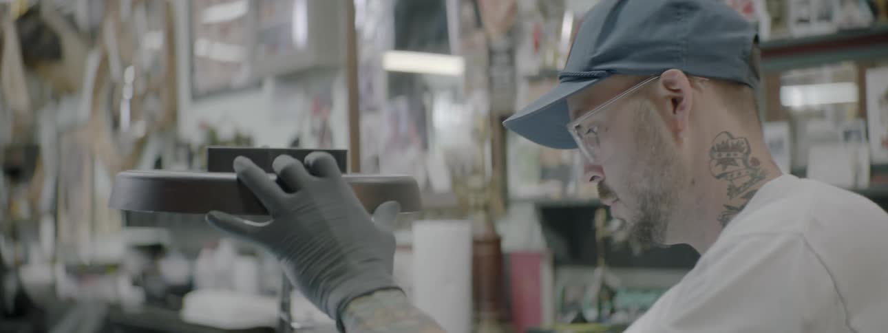 A tattoo artist readies his station in an art studio