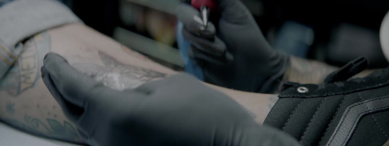 A person getting a tattoo on their leg
