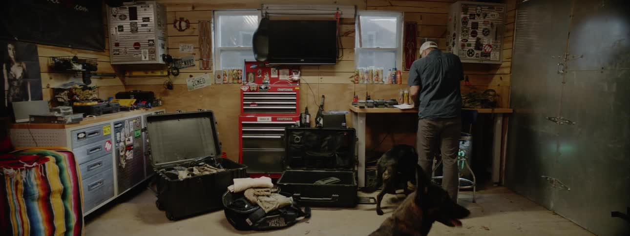 A man and dogs walk into a workshop