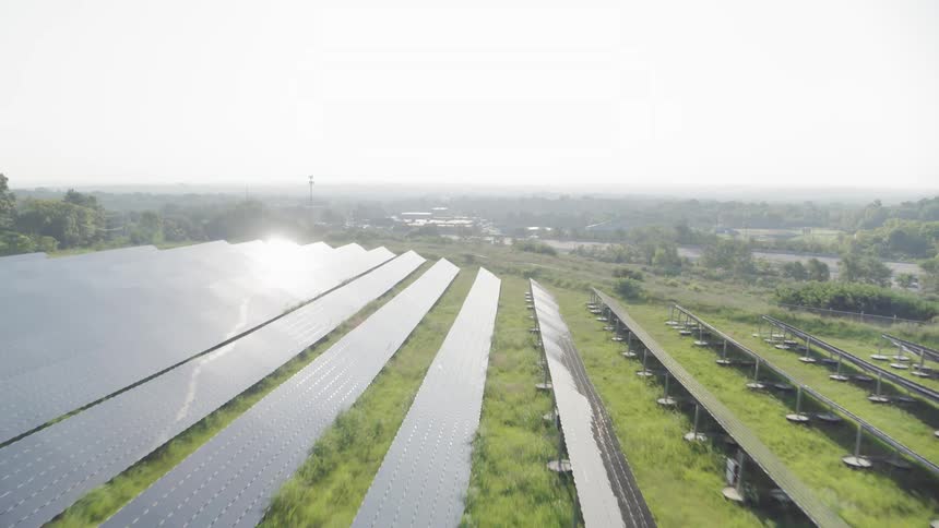 A large array of solar panels on a hillside