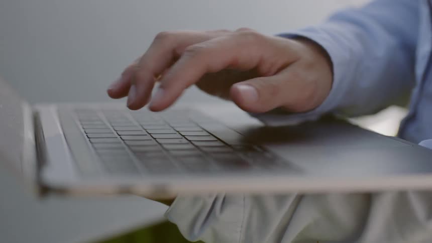 A woman typing on a laptop