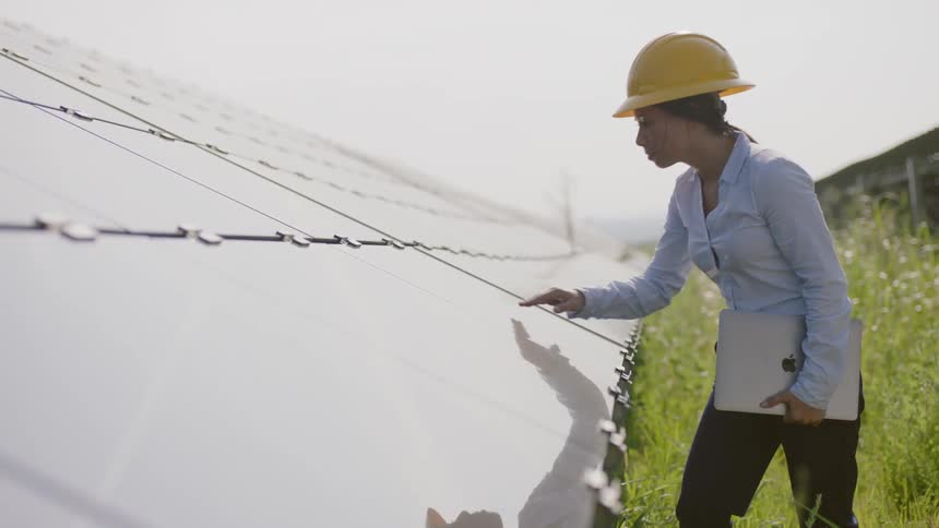 A construction worker inspects something