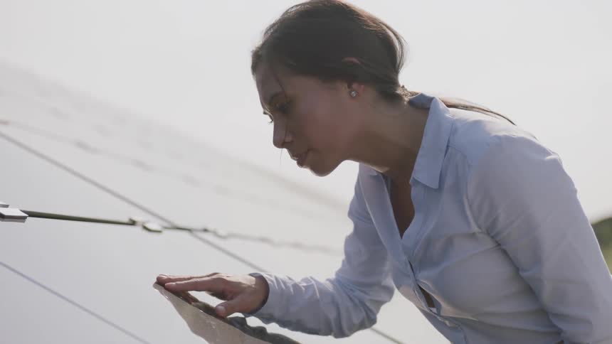 Woman inspecting solar panels