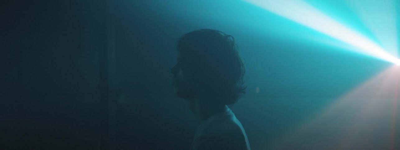 Person standing in a room with flashing strobe lights