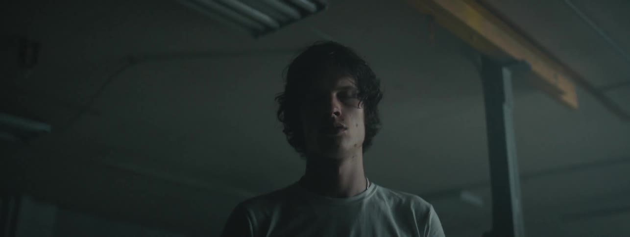 Man stands in room under flashing lights