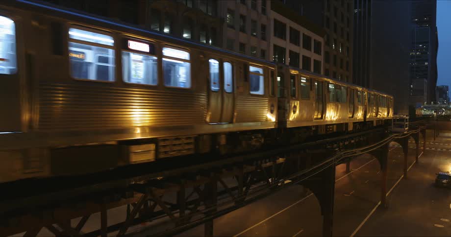 Train passes through the city at dusk