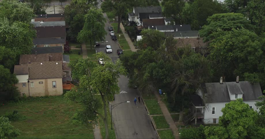 Cars travel down the street in the town