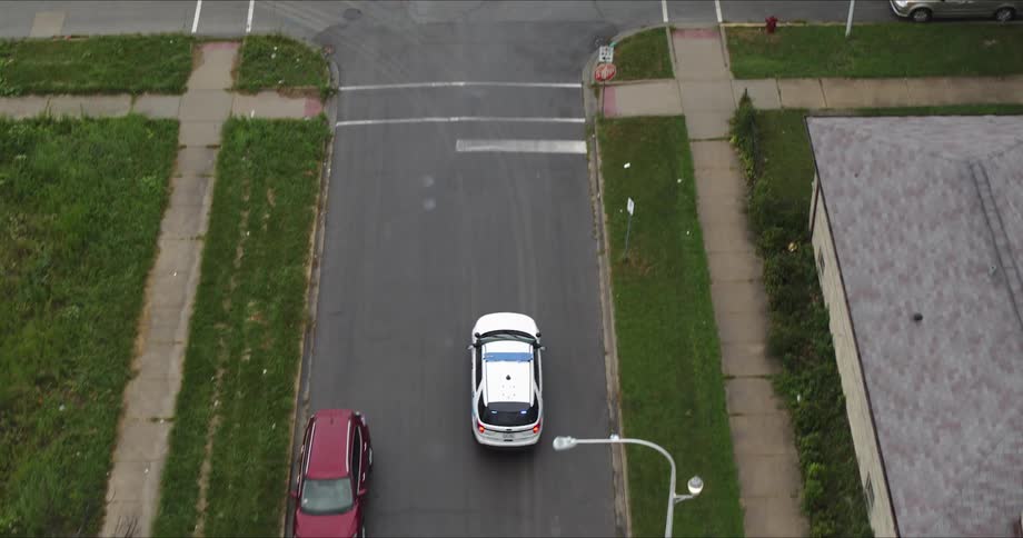 Aerial view of a police car driving down the street