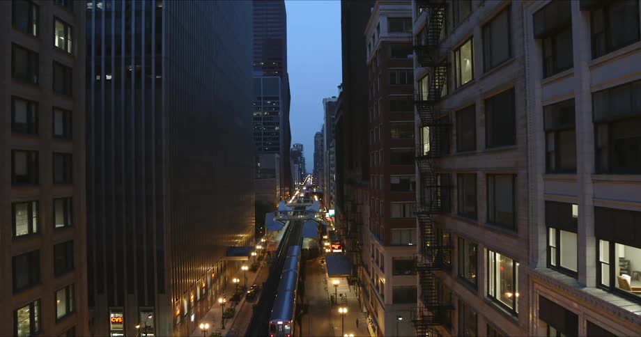 A subway train traveling on tracks through a city