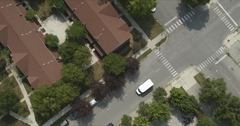 Traffic drives through a residential area