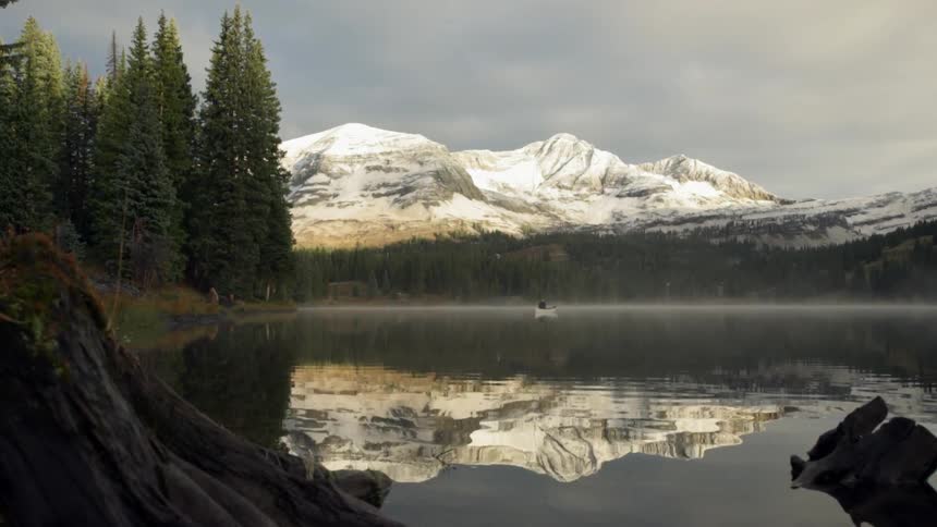 Mountains are shown hovering over a lake