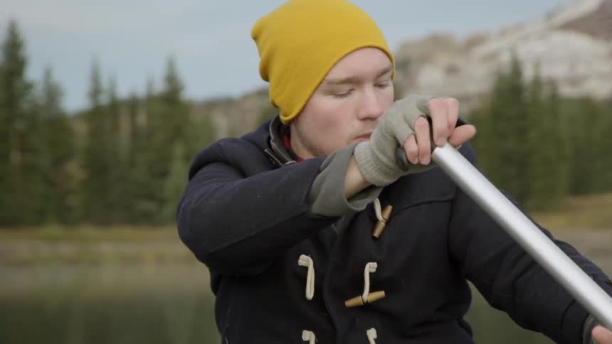 A boy is rowing in the water