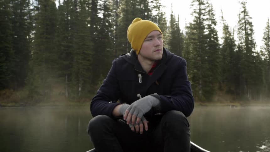 Man sits in boat floating on water
