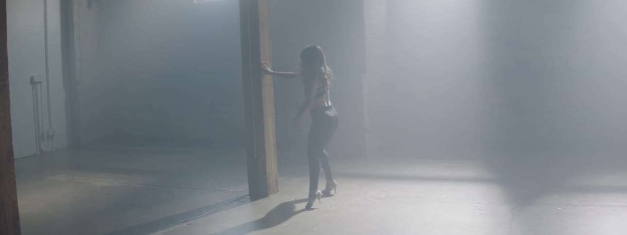 A woman dances and twirls in a dance studio