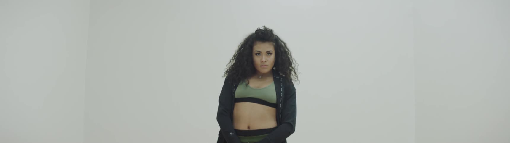 A woman dances in a white room