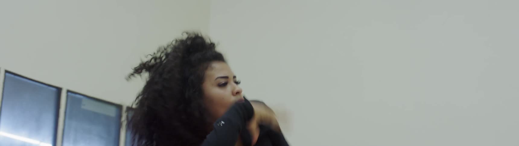 A woman in a dance studio dancing