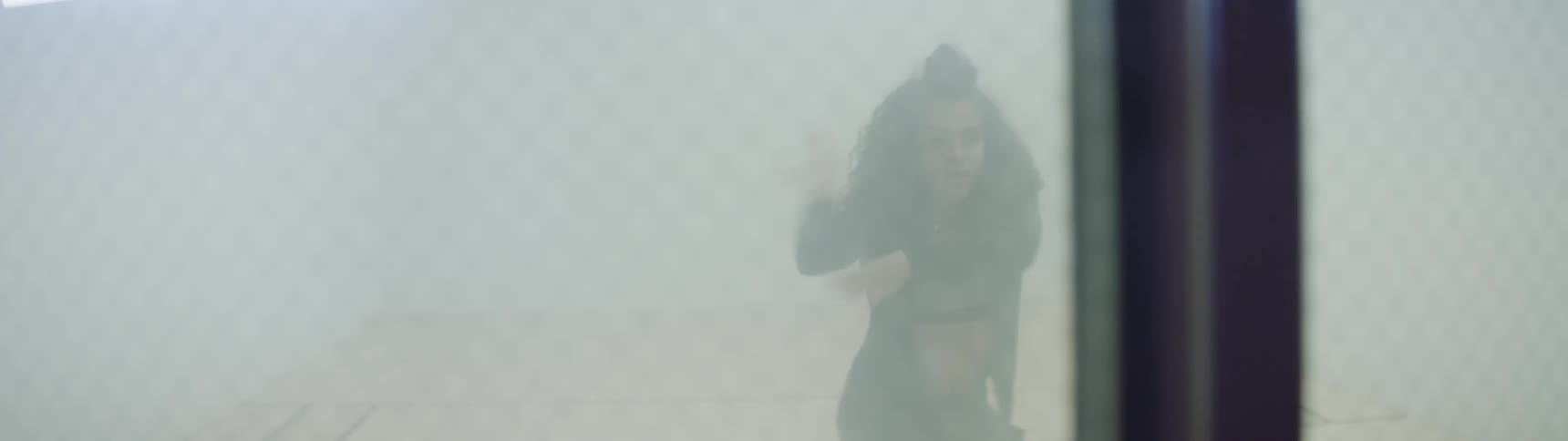 A woman indoors dancing