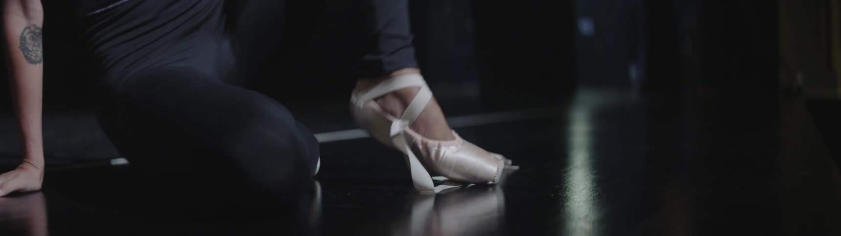 A dancer stretches out her ankle
