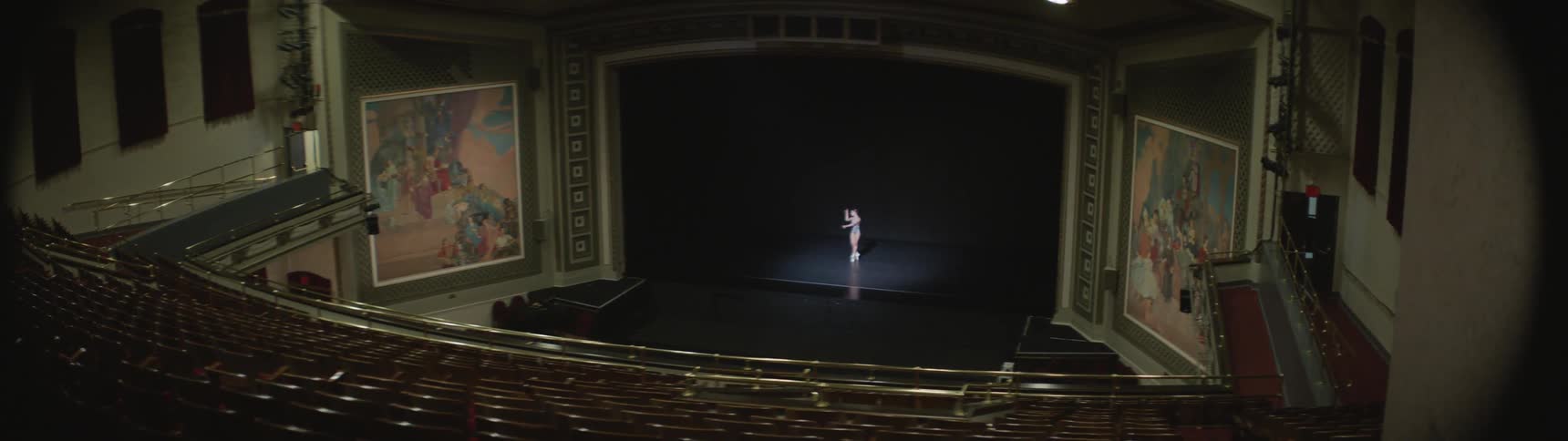A ballerina dances on a theater stage